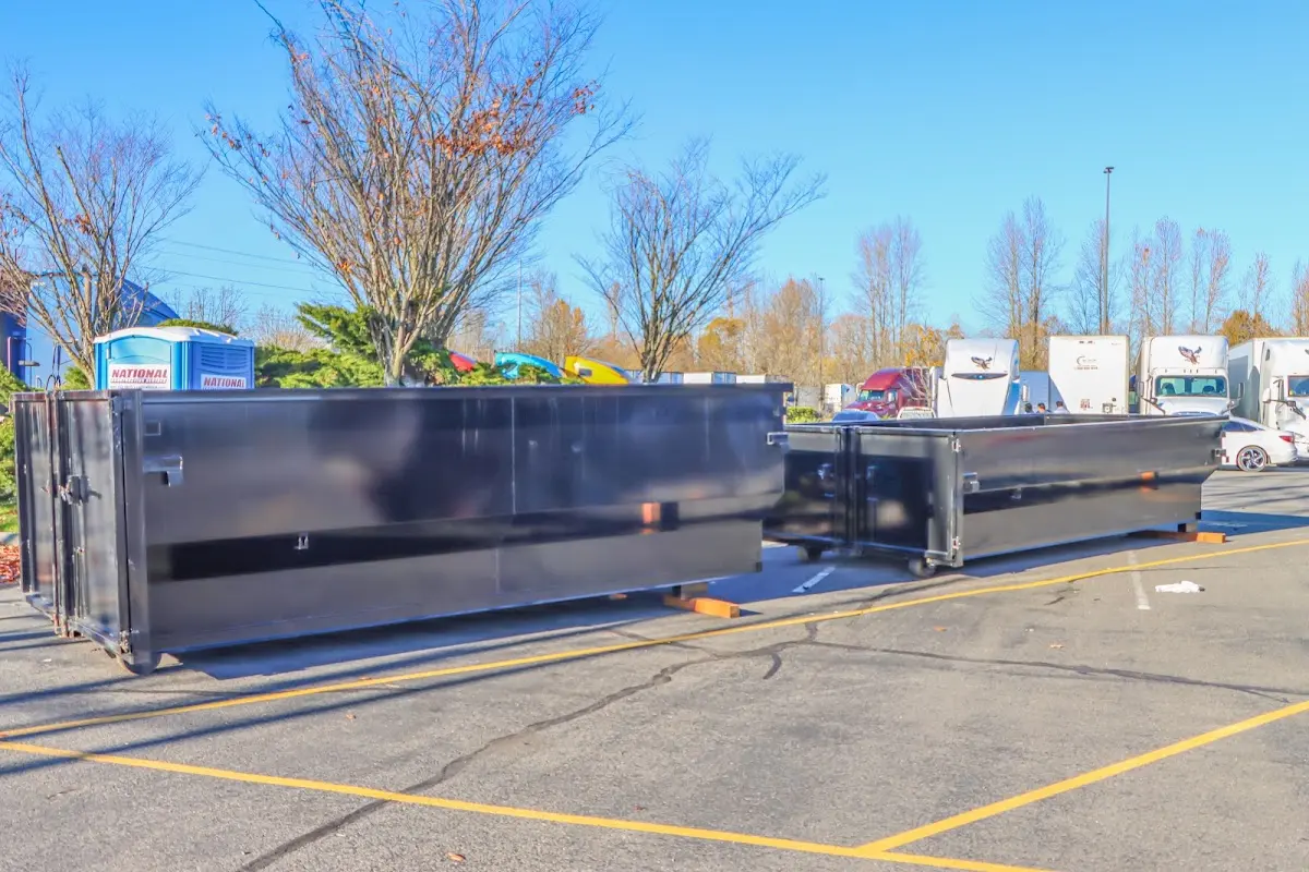 Professional dumpster rental service with roll-off container on residential driveway in Roseburg
